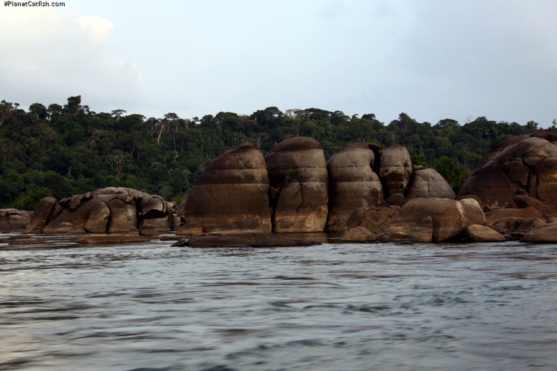 Massive granite rocks rounded by the ages and lined by high-water levels, the cracks and fissures you see above water are the same below